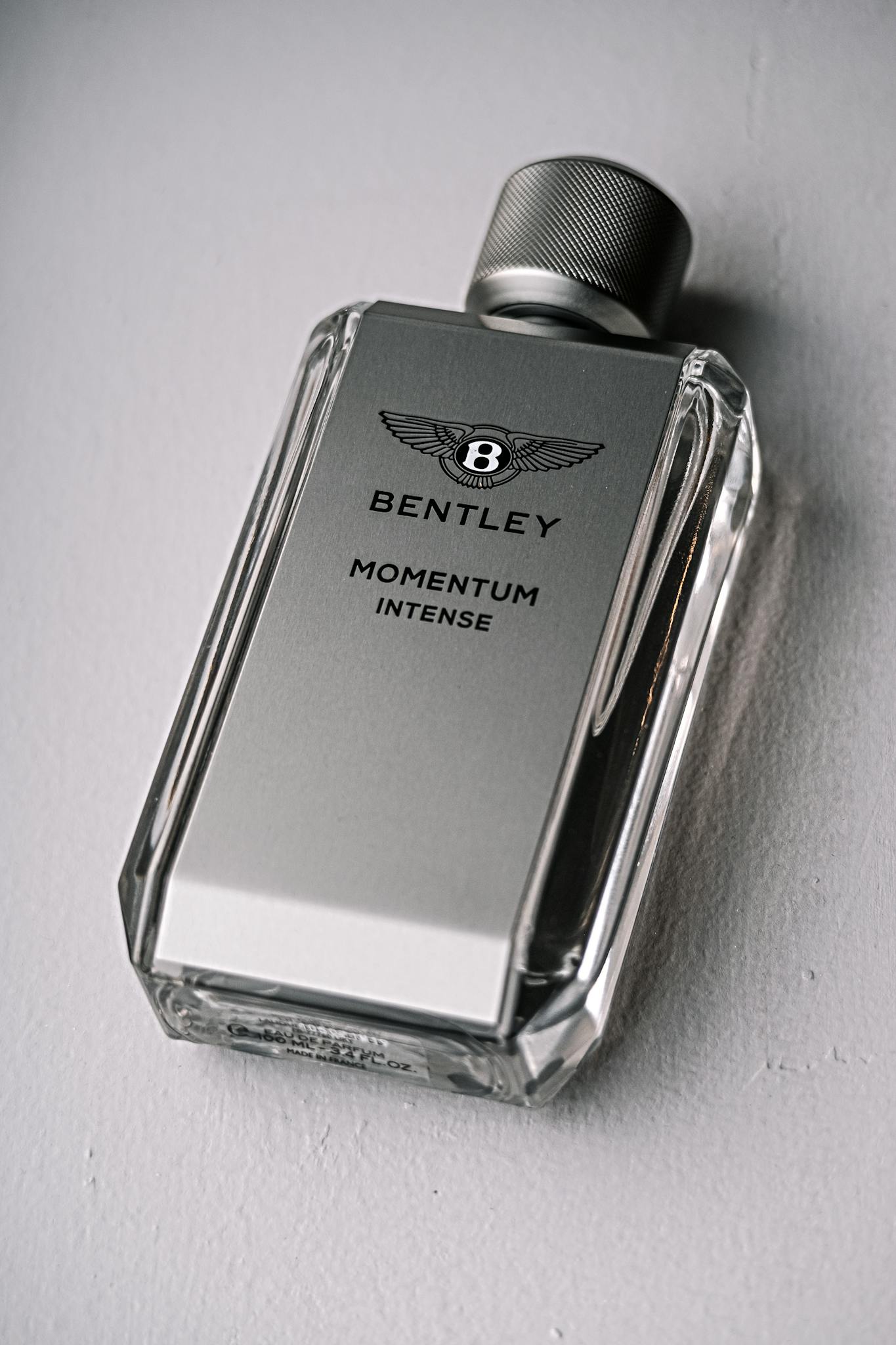 Elegant Bentley Momentum Intense perfume bottle captured in a sleek product shot.